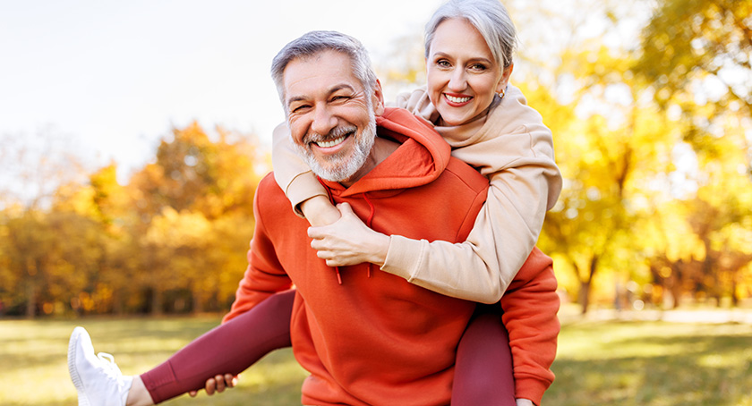 Man and woman outside smiling