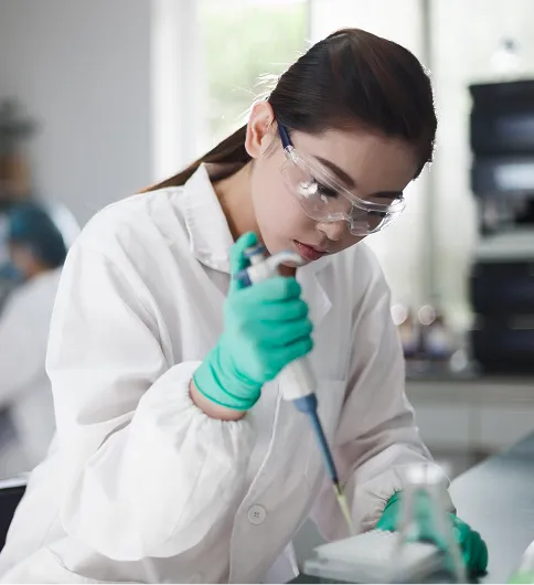ubiquinol-sample-testing-laboratory Laboratory researcher examines a sample under a microscope, representing scientific testing and nutraceutical ingredient quality control.